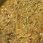 Crawfish fettuccine in a pot, creamy sauce with crawfish tails and green onion