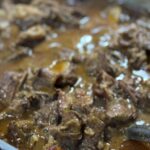 Close up of smothered beef in rich brown gravy