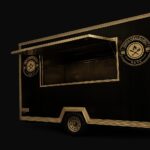 The Third Generation Eats food trailer, black with gold trim and the crest logo on the side